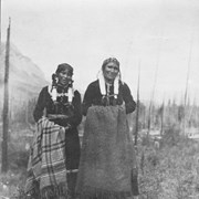 Cover image of Two unidentified women standing in field with shawls